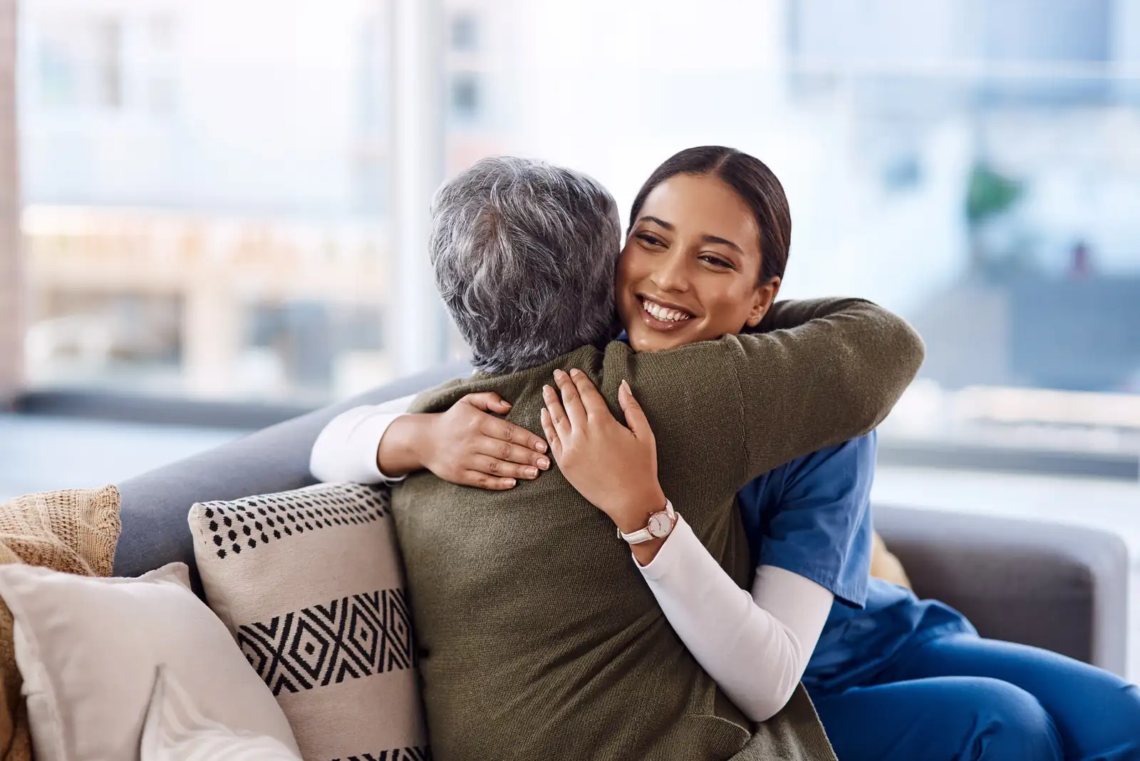 Carer embracing her elderly client warmly