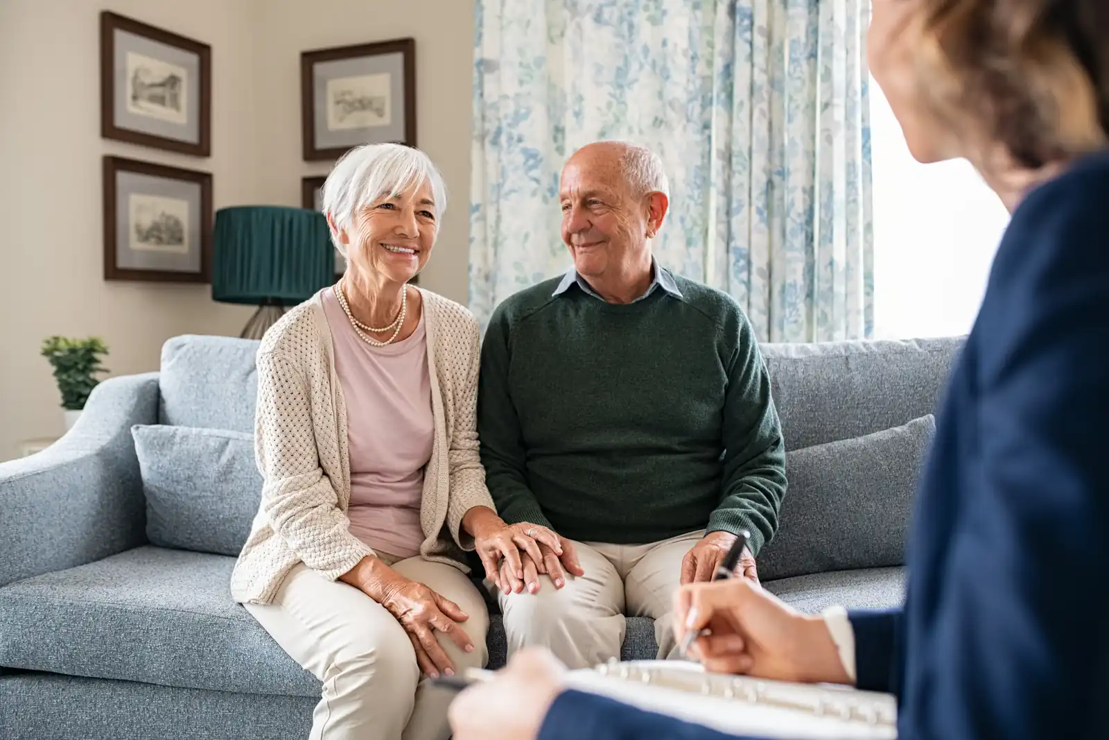 An older couple meeting a care professional at home